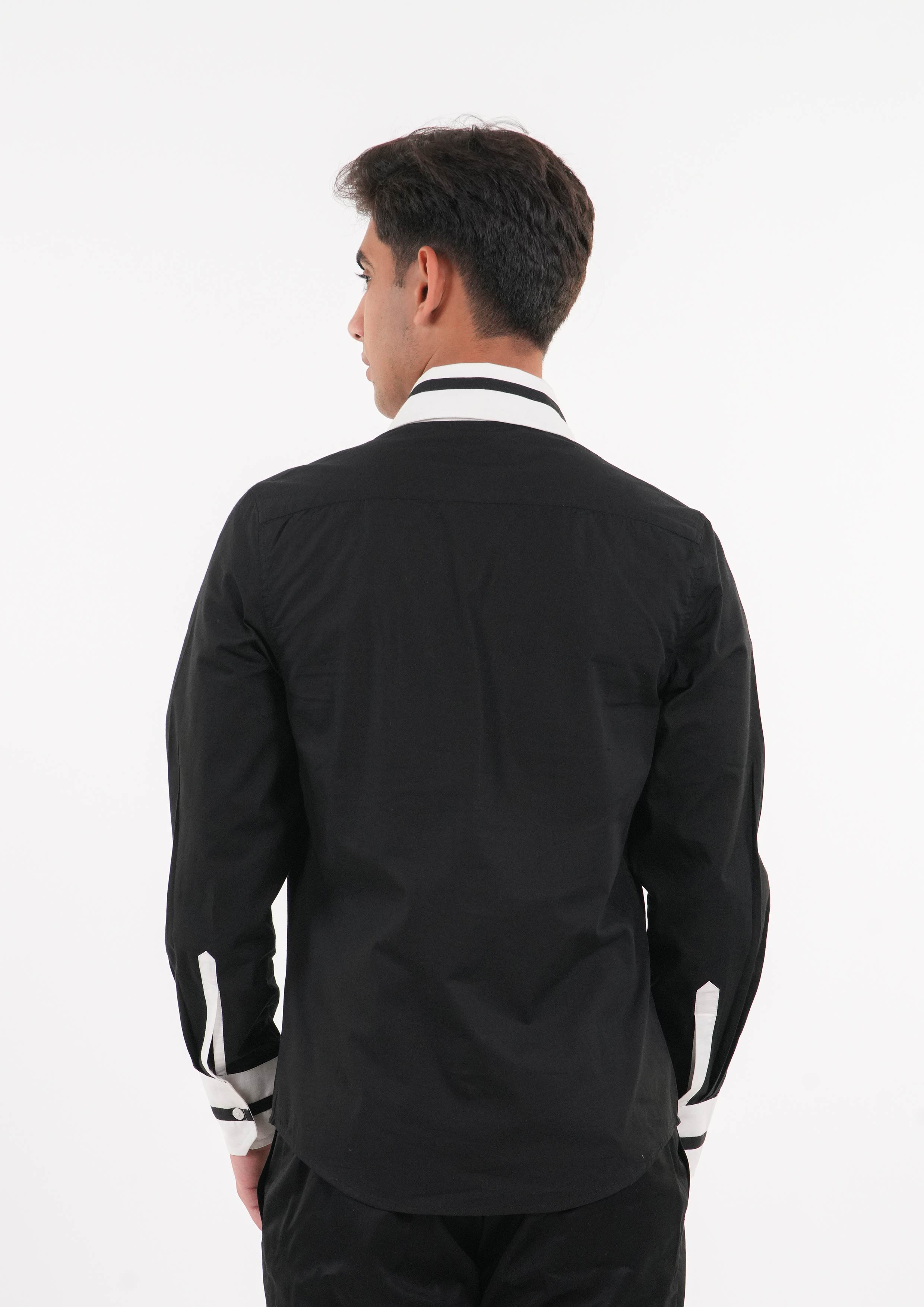 Man wearing a black shirt with white accents on a white background